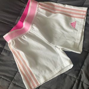 White Adidas XS dryfit shorts with thick pink waistband and soft orange stripes